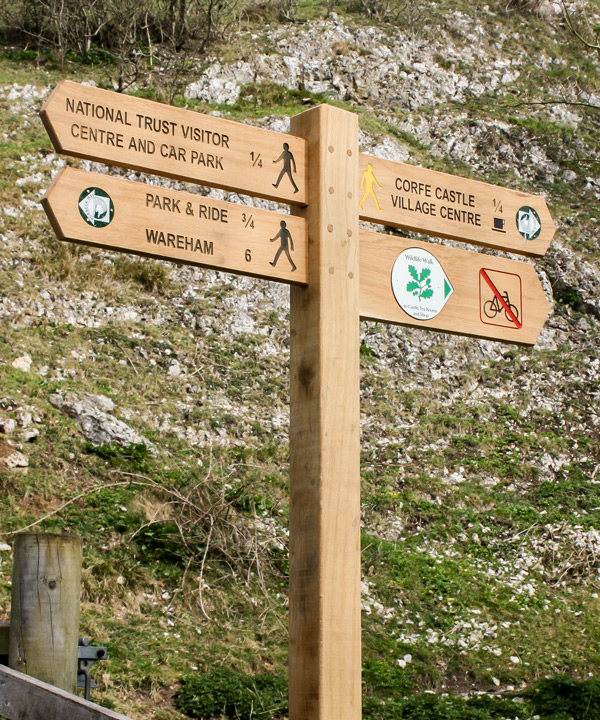 Wooden Fingerpost Sign with engraved, infilled lettering and recessed bespoke waymarker discs.