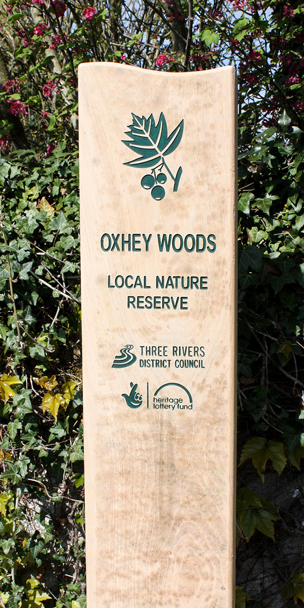 Wooden Monolith Entrance Sign with curved top and engraved and infilled lettering