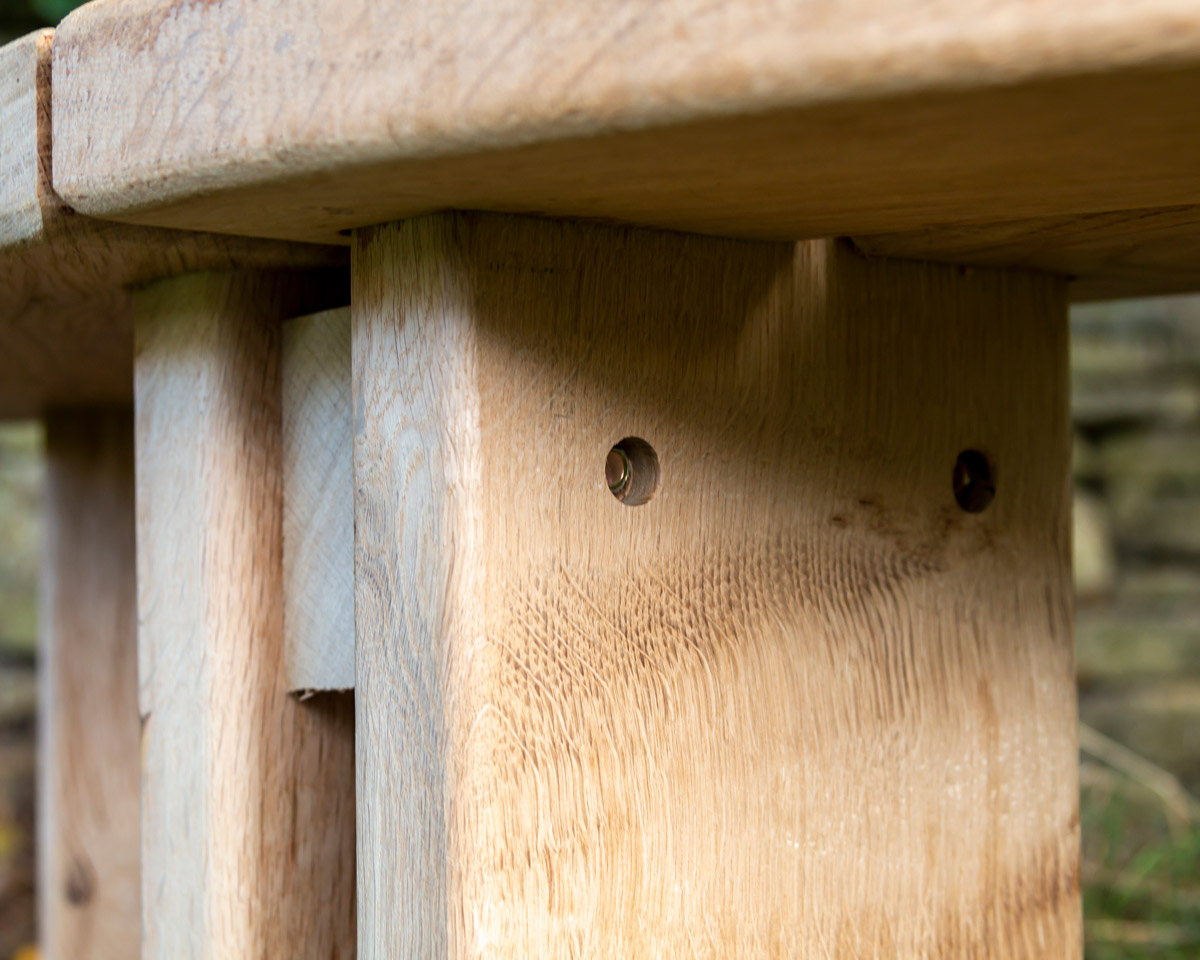 Two 45° curved oak bench segments securely fastened together.